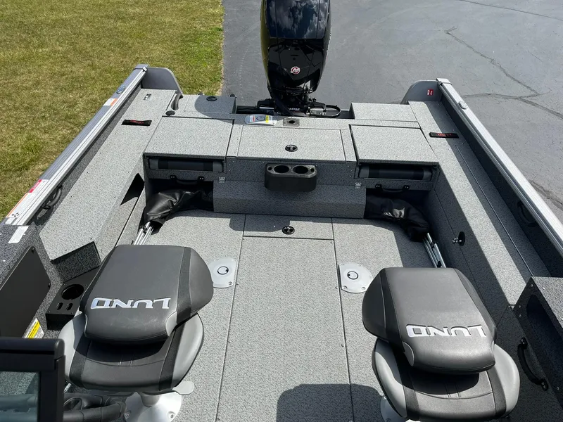 Slide: The Image of 2026 Lund 1875 Impact XS Sport boat interior with seating and storage compartments. - 10
