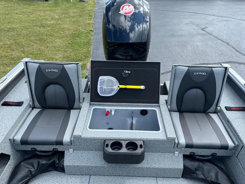 Slide: The Image of 2026 Lund 1875 Impact XS Sport boat interior with seating and storage compartments. - 11