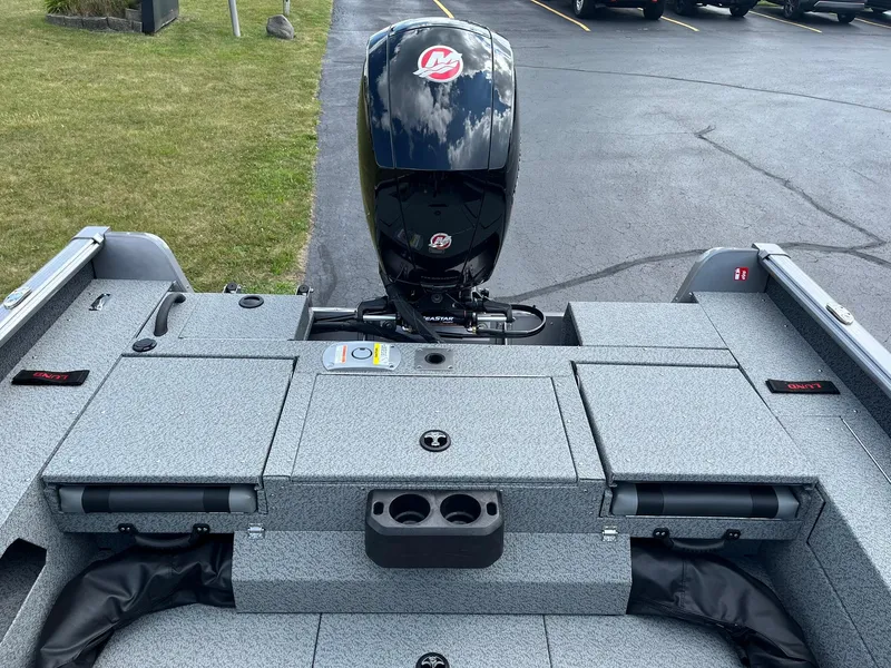 Slide: The Image of 2026 Lund 1875 Impact XS Sport boat with outboard motor, parked on asphalt. - 12