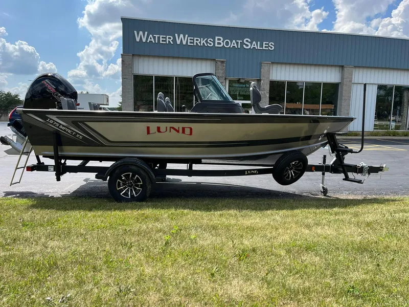 Slide: The Image of 2026 Lund 1875 Impact XS Sport boat at Water Werks Boat Sales dealership. - 2