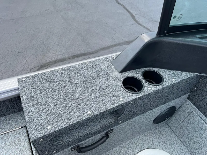 Slide: The Image of Interior of 2026 Lund 1875 Impact XS Sport boat with cup holders and textured surface. - 21