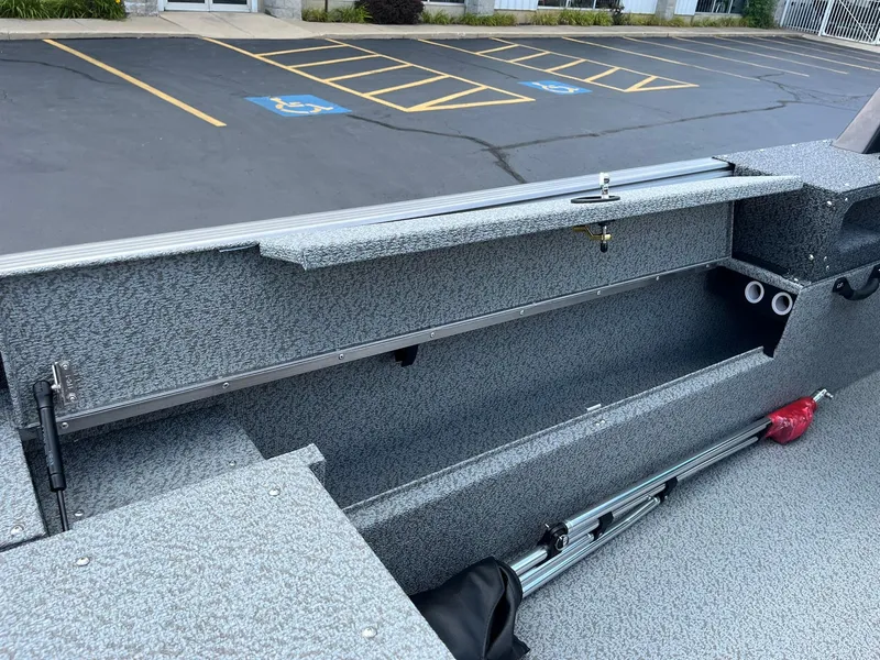 Slide: The Image of Interior view of 2026 Lund 1875 Impact XS Sport boat storage compartment. - 24