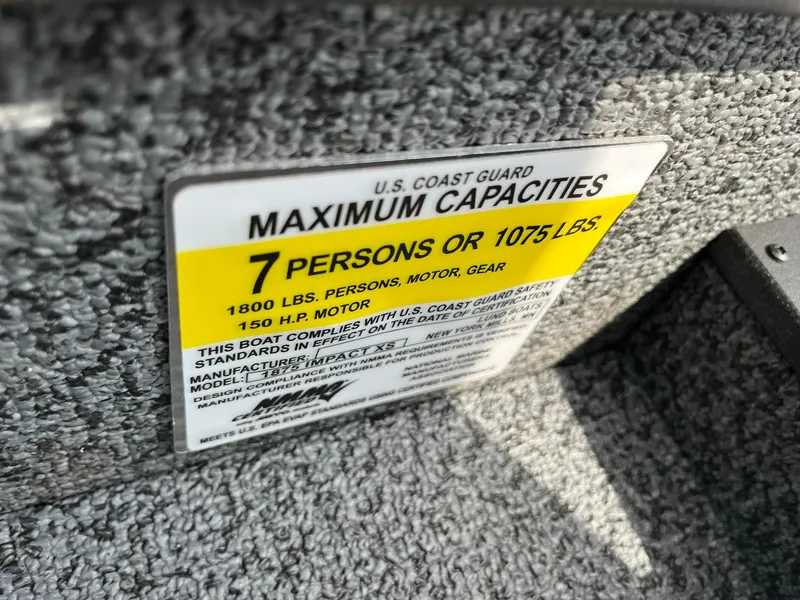 Slide: The Image of Capacity label on 2026 Lund 1875 Impact XS Sport boat, 7 persons or 1075 lbs. - 28