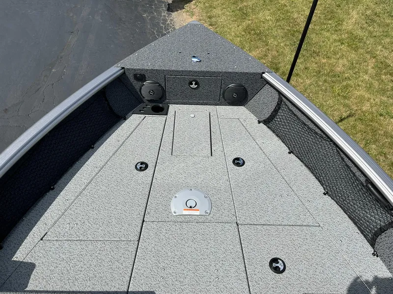 Slide: The Image of 2026 Lund 1875 Impact XS Sport boat deck with storage compartments and speakers. - 8