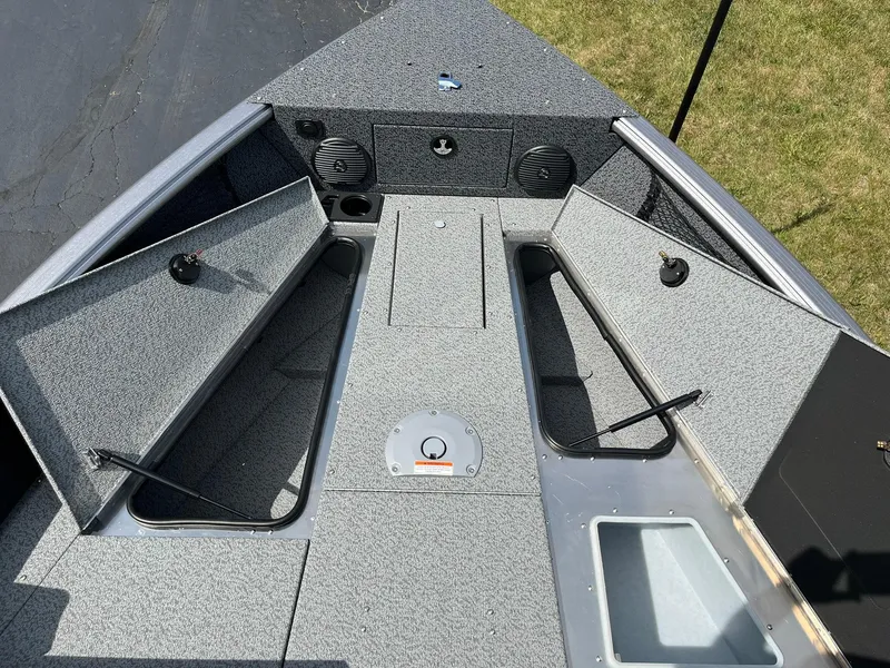 Slide: The Image of 2026 Lund 1875 Impact XS Sport boat interior with open storage compartments. - 9