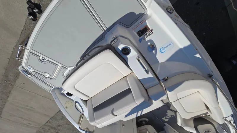 Slide: The Image of 2018 Chaparral 224 Sunesta boat interior with white seating and control panel. - 11