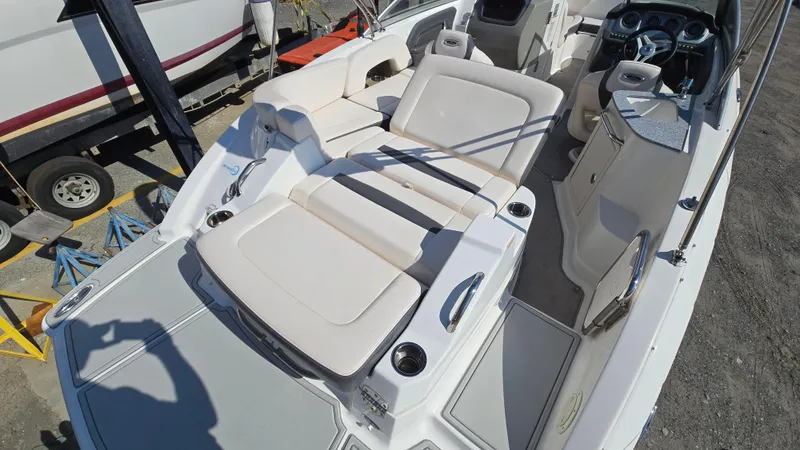 Slide: The Image of 2018 Chaparral 224 Sunesta boat interior with spacious seating and modern dashboard. - 12