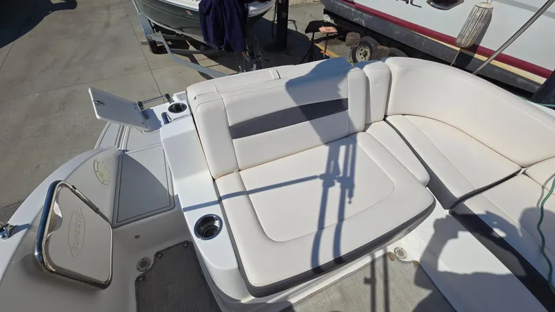 Slide: The Image of 2018 Chaparral 224 Sunesta boat interior with white seating and cup holders. - 14
