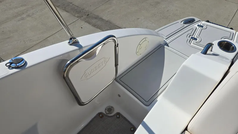 Slide: The Image of 2018 Chaparral 224 Sunesta boat interior with Sunesta-branded door and cup holders. - 18