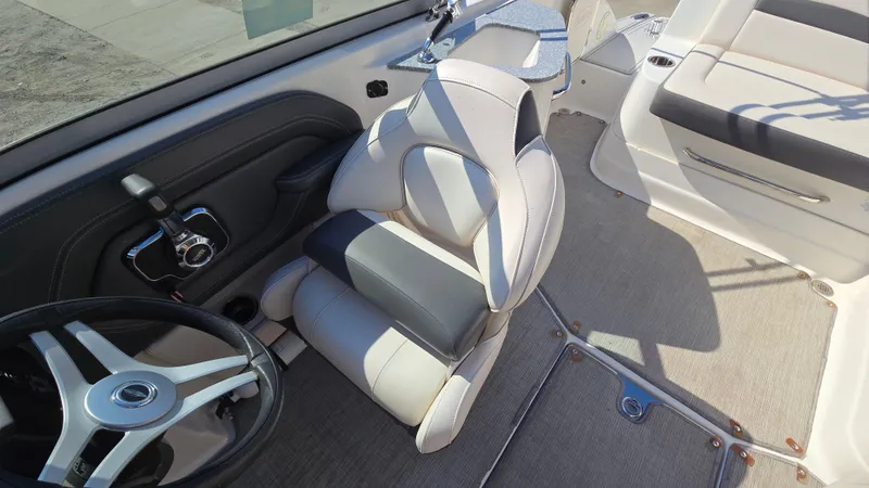 Slide: The Image of 2018 Chaparral 224 Sunesta boat interior with steering wheel and seating. - 22