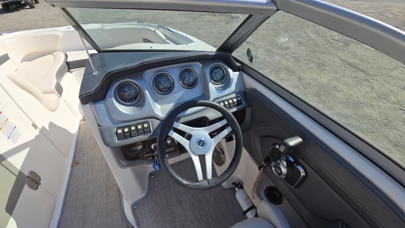 Slide: The Image of 2018 Chaparral 224 Sunesta boat dashboard with steering wheel and gauges. - 23