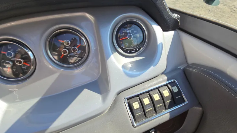 Slide: The Image of Dashboard of 2018 Chaparral 224 Sunesta boat with gauges and switches. - 25