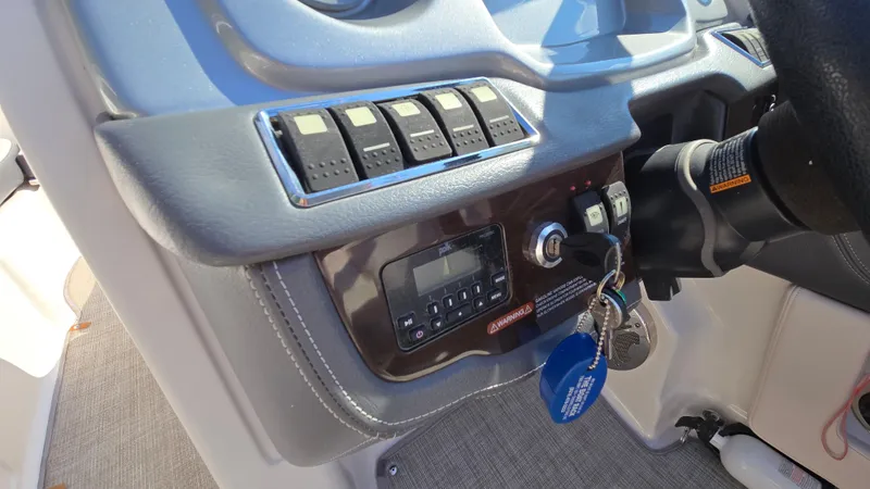 Slide: The Image of Dashboard of a 2018 Chaparral 224 Sunesta boat with control panel and keys. - 26