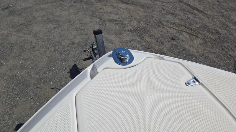 Slide: The Image of Bow of 2018 Chaparral 224 Sunesta boat on a trailer, parked on gravel. - 33