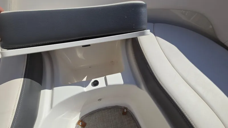 Slide: The Image of 2018 Chaparral 224 Sunesta boat seat storage compartment open. - 35
