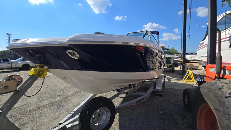 Slide: The Image of 2018 Chaparral 224 Sunesta boat on trailer under clear blue sky. - 4