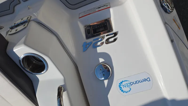 Slide: The Image of 2018 Chaparral 224 Sunesta boat deck with cup holder and branding. - 43