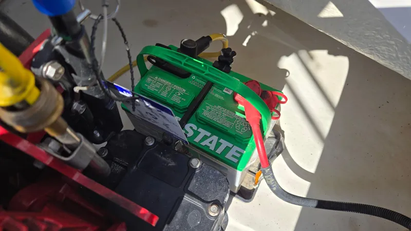 Slide: The Image of Battery setup in a 2018 Chaparral 224 Sunesta boat engine compartment. - 46