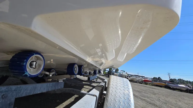 Slide: The Image of 2018 Chaparral 224 Sunesta boat on trailer, close-up view of hull and rollers. - 7