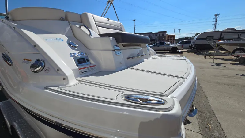 Slide: The Image of 2018 Chaparral 224 Sunesta boat rear view, showcasing swim platform and seating. - 8