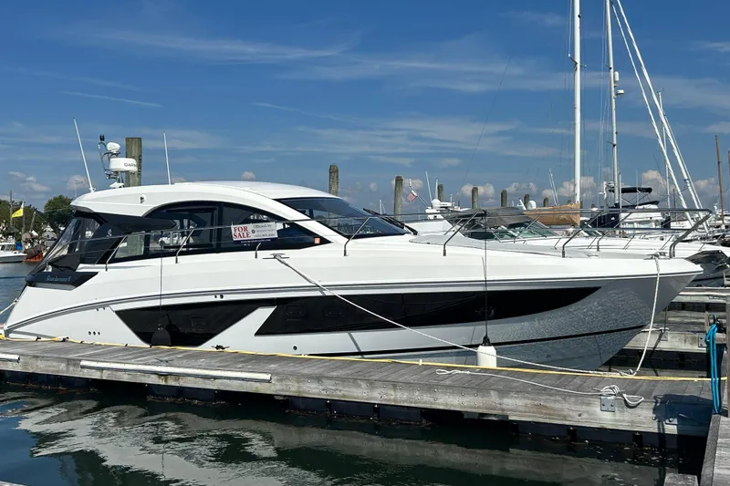 Slide: The Image of 2023 Beneteau Gran Turismo 41 yacht docked, for sale, under clear blue sky. - 13
