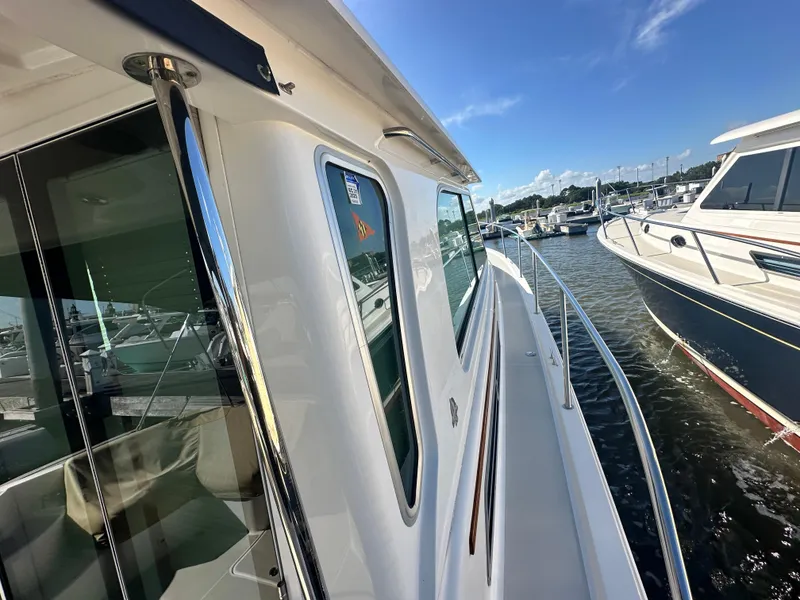 Slide: The Image of 2014 Back Cove 37 yacht docked at marina, sunny day, clear blue sky. - 11