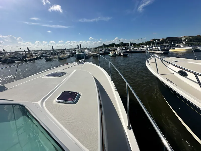 Slide: The Image of 2014 Back Cove 37 yacht docked at marina under clear blue sky. - 13