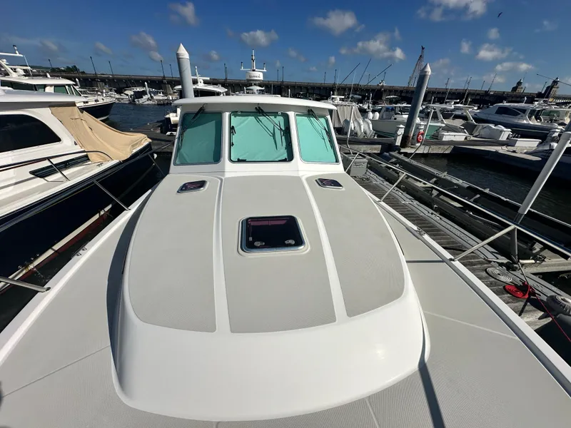 Slide: The Image of 2014 Back Cove 37 yacht docked at marina under clear blue sky. - 15
