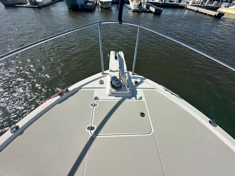 Slide: The Image of Bow view of 2014 Back Cove 37 yacht at marina, featuring anchor and railings. - 16
