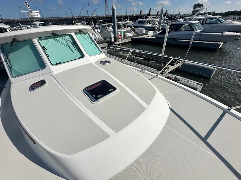 Slide: The Image of 2014 Back Cove 37 yacht docked at marina, showcasing sleek deck design. - 18