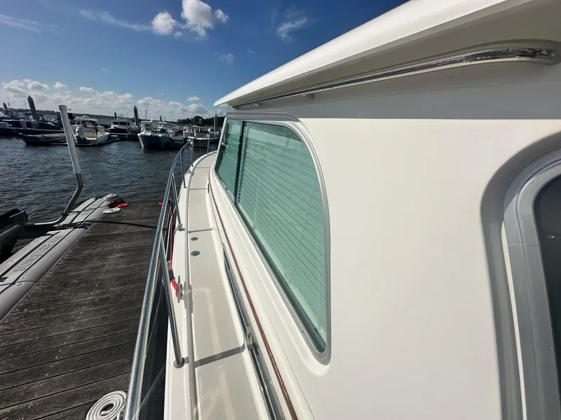 Slide: The Image of 2014 Back Cove 37 yacht docked at marina under clear blue sky. - 20