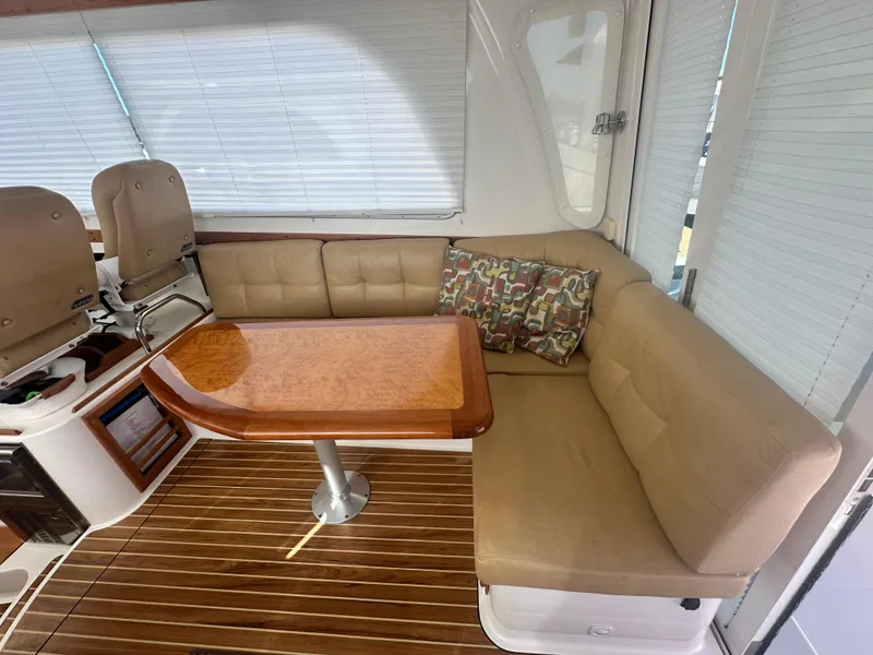Slide: The Image of Luxurious interior of 2014 Back Cove 37 yacht with beige seating and wooden table. - 23
