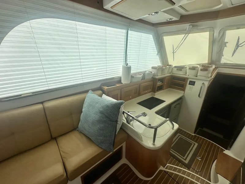 Slide: The Image of 2014 Back Cove 37 yacht interior with kitchen, sofa, and wooden flooring. - 26