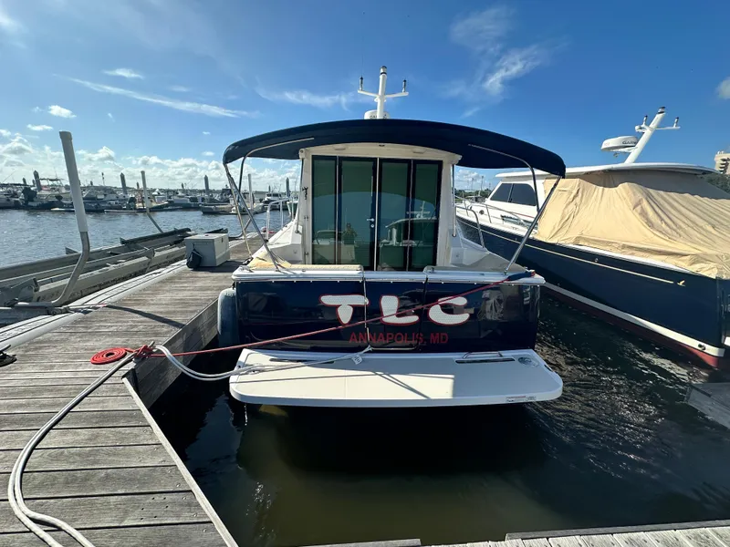 Slide: The Image of 2014 Back Cove 37 boat docked in Annapolis marina under clear blue sky. - 3