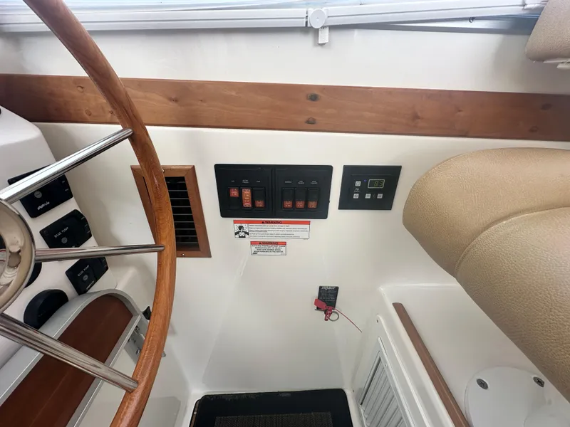 Slide: The Image of 2014 Back Cove 37 helm with wooden steering wheel and control panel. - 31