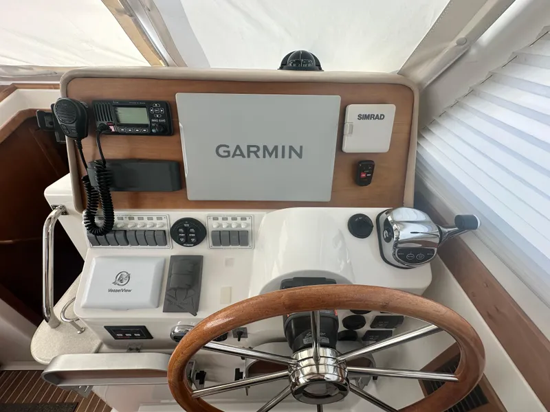 Slide: The Image of Helm of 2014 Back Cove 37 with Garmin and Simrad navigation systems. - 32