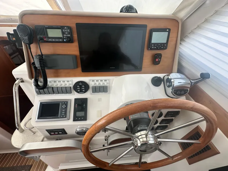Slide: The Image of Helm of 2014 Back Cove 37 boat with steering wheel and navigation equipment. - 34