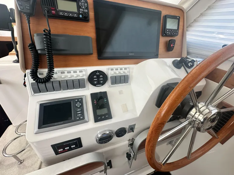 Slide: The Image of Helm of 2014 Back Cove 37 boat with navigation equipment and wooden steering wheel. - 35