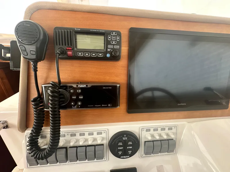 Slide: The Image of Control panel of a 2014 Back Cove 37 boat with radio and Garmin display. - 36
