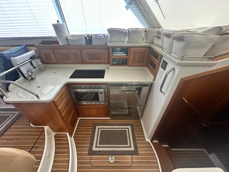 Slide: The Image of Luxurious 2014 Back Cove 37 yacht kitchen with modern appliances and elegant wood cabinetry. - 37