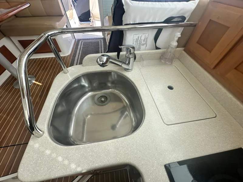 Slide: The Image of 2014 Back Cove 37 yacht kitchen sink with stainless steel basin and faucet. - 38