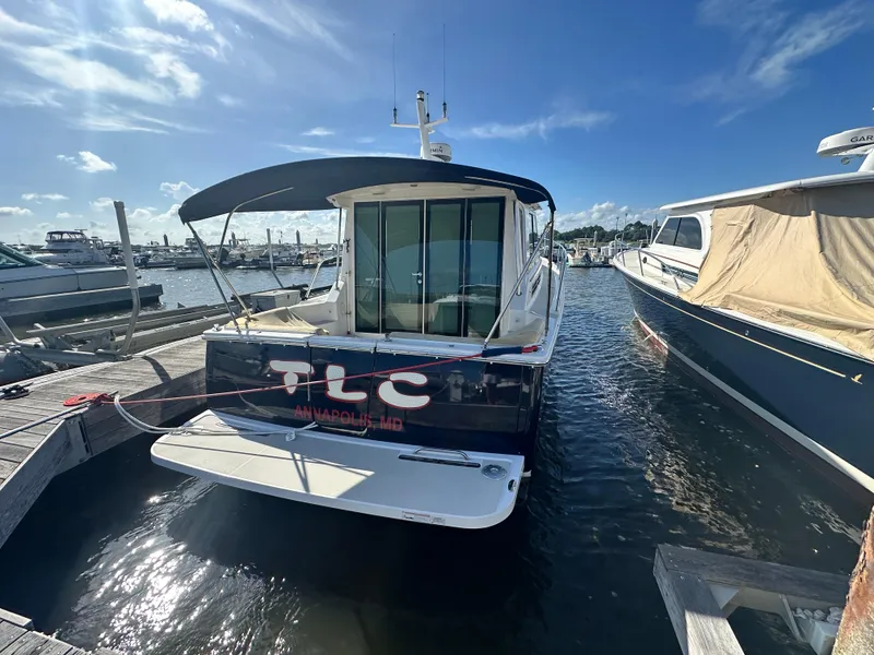 Slide: The Image of 2014 Back Cove 37 boat docked in Annapolis, Maryland under a clear blue sky. - 4