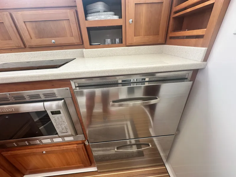 Slide: The Image of 2014 Back Cove 37 yacht kitchen with stainless steel appliances and wooden cabinetry. - 41