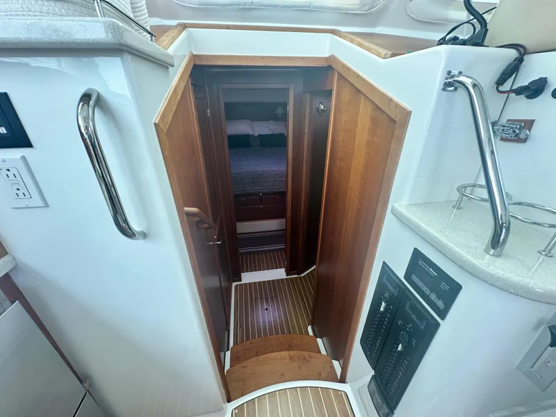 Slide: The Image of Interior view of 2014 Back Cove 37 yacht, featuring wooden steps and cabin entrance. - 42