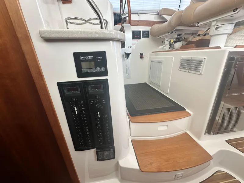 Slide: The Image of 2014 Back Cove 37 yacht interior with control panel and wooden steps. - 43