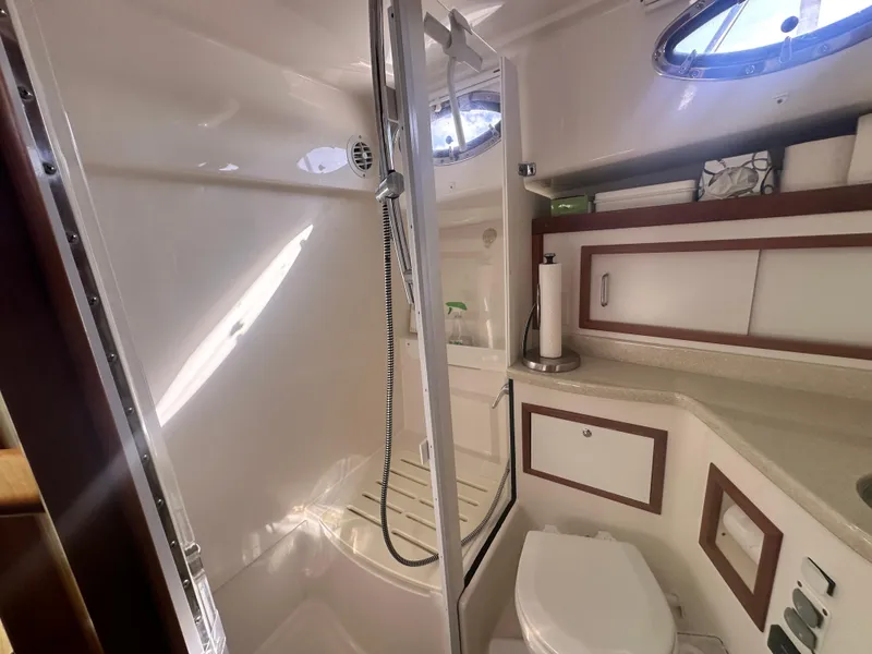 Slide: The Image of 2014 Back Cove 37 yacht bathroom with shower, toilet, and storage cabinets. - 47