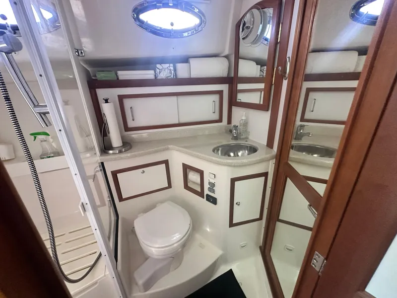 Slide: The Image of 2014 Back Cove 37 yacht bathroom with sink, toilet, and storage cabinets. - 48