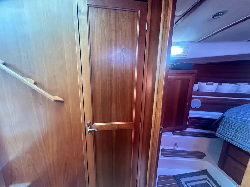 Slide: The Image of Interior of 2014 Back Cove 37 yacht with wooden cabinetry and cozy sleeping area. - 49