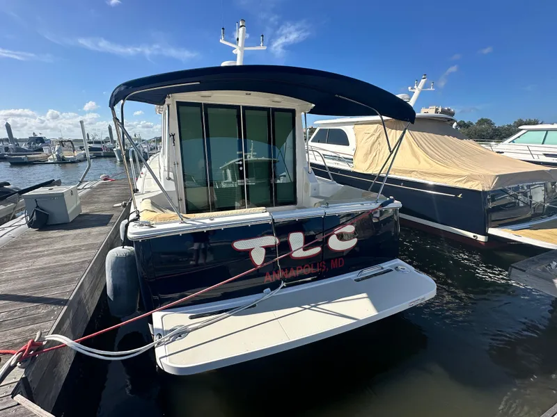Slide: The Image of 2014 Back Cove 37 yacht docked in marina, Annapolis, MD, under clear blue sky. - 5
