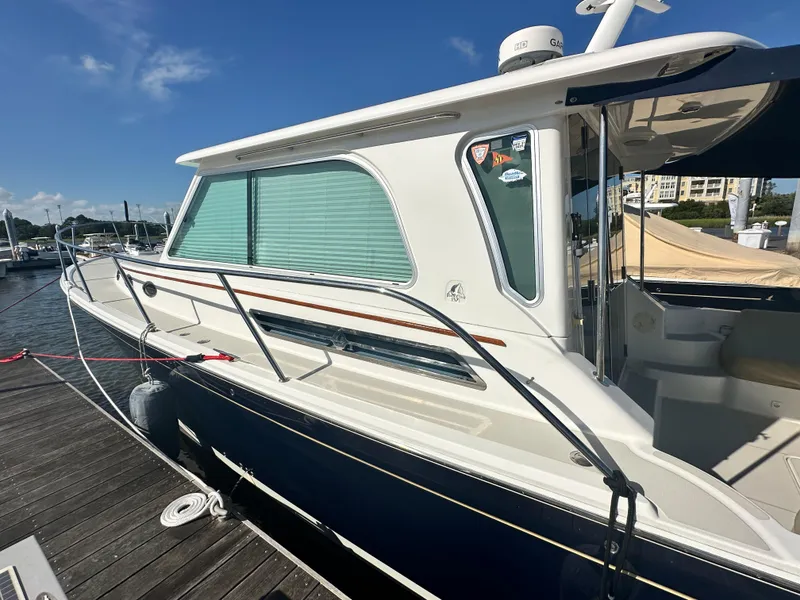 Slide: The Image of 2014 Back Cove 37 boat docked at marina under clear blue sky. - 7